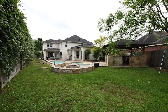 7414 Regency Pl, Spring, TX 77379 - back of property with a lawn, an in ground hot tub, a fenced backyard, and a gazebo