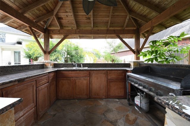view of patio / terrace featuring ceiling fan, a sink, area for grilling, exterior kitchen, and a gazebo