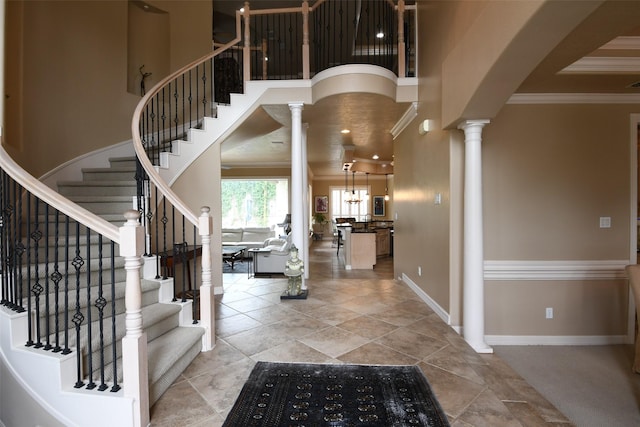 7414 Regency Pl, Spring, TX 77379 - entryway featuring crown molding, baseboards, ornate columns, and stairs