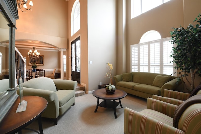 7414 Regency Pl, Spring, TX 77379 - living area featuring decorative columns, a notable chandelier, plenty of natural light, and a towering ceiling