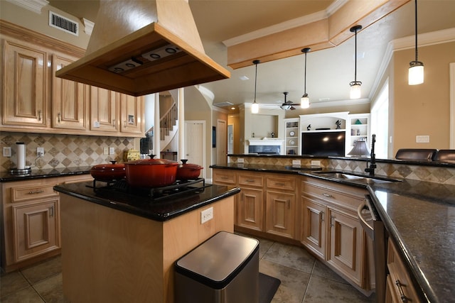 kitchen with a sink, decorative backsplash, ornamental molding, and visible vents