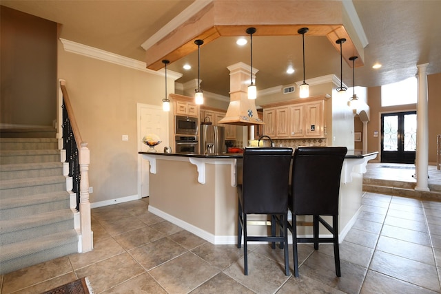 kitchen with crown molding, appliances with stainless steel finishes, a kitchen bar, and dark countertops