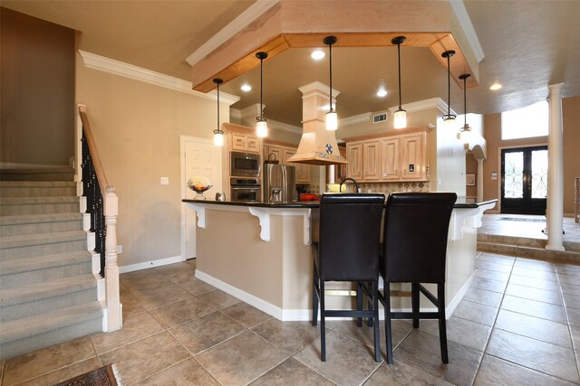 7414 Regency Pl, Spring, TX 77379 - kitchen with crown molding, appliances with stainless steel finishes, a kitchen bar, and dark countertops