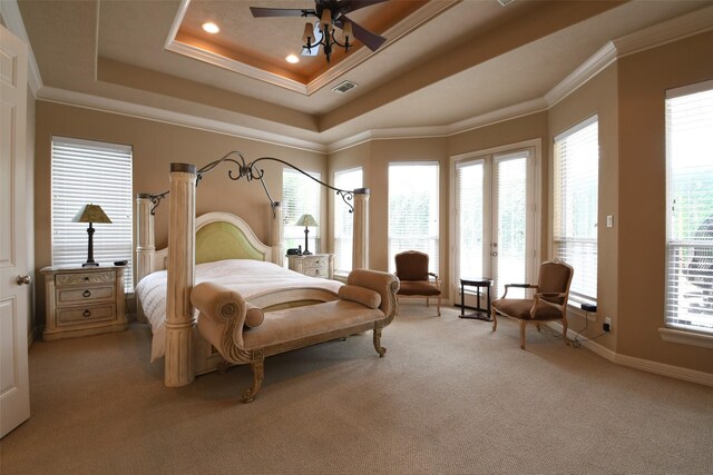 7414 Regency Pl, Spring, TX 77379 - bedroom featuring visible vents, access to exterior, ornamental molding, light carpet, and a tray ceiling