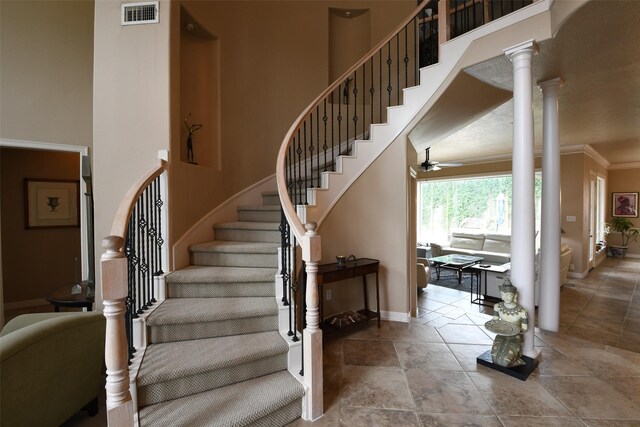 7414 Regency Pl, Spring, TX 77379 - stairs featuring baseboards, visible vents, ceiling fan, and a high ceiling