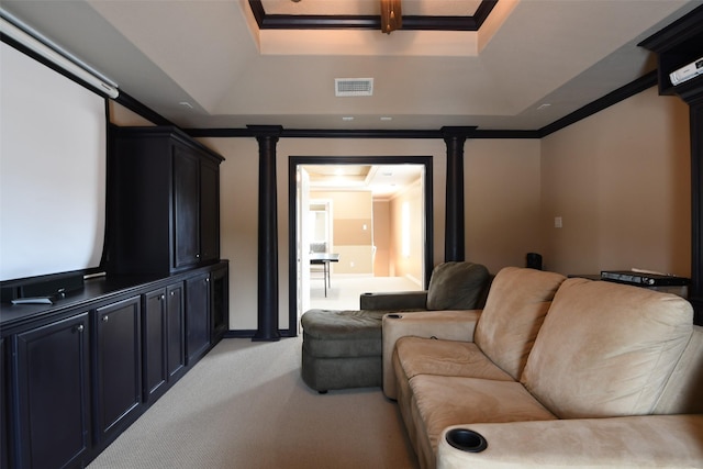home theater with visible vents, ornamental molding, a raised ceiling, and light carpet
