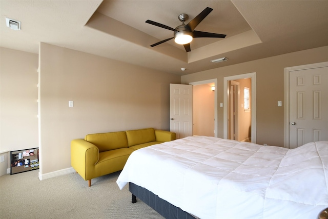 bedroom with visible vents, a ceiling fan, a raised ceiling, and carpet floors