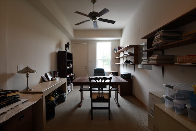 carpeted office with ceiling fan and baseboards
