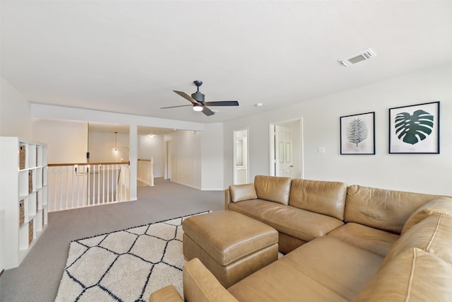 carpeted living room featuring ceiling fan, baseboards, and visible vents