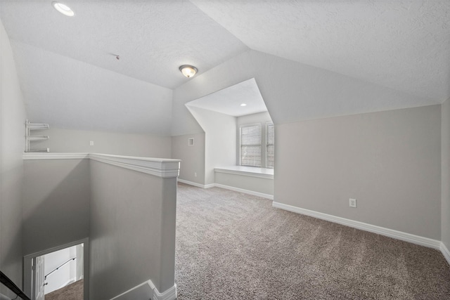 13611 Brookbluff Ln, Houston, TX 77077 - bonus room featuring baseboards, lofted ceiling, a textured ceiling, and carpet