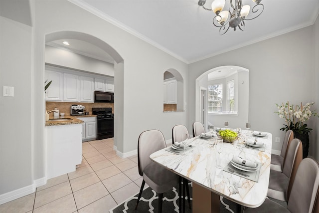 13611 Brookbluff Ln, Houston, TX 77077 - dining area with a chandelier, light tile patterned floors, arched walkways, baseboards, and ornamental molding