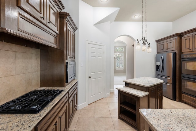 1614 Beau Rivage, Conroe, TX 77304 - kitchen with black appliances, tasteful backsplash, light tile patterned flooring, open shelves, and light stone counters