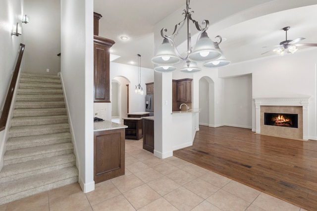 1614 Beau Rivage, Conroe, TX 77304 - kitchen with arched walkways, open floor plan, a chandelier, light tile patterned floors, and recessed lighting