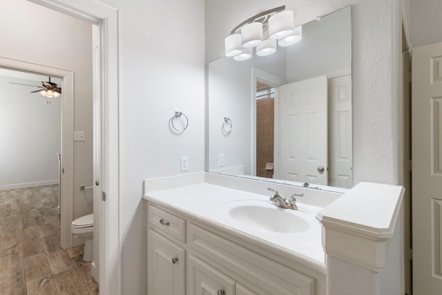 1614 Beau Rivage, Conroe, TX 77304 - bathroom with toilet, ceiling fan, vanity, and wood finished floors
