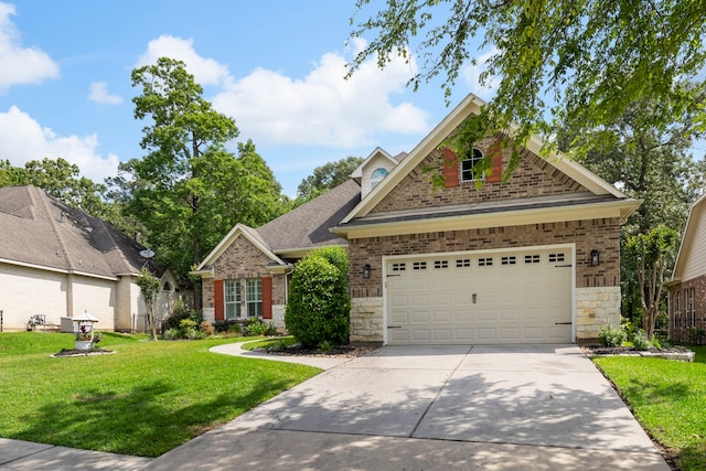 1614 Beau Rivage, Conroe, TX 77304 - view of front of property featuring concrete driveway, a front yard, stone siding, and brick siding