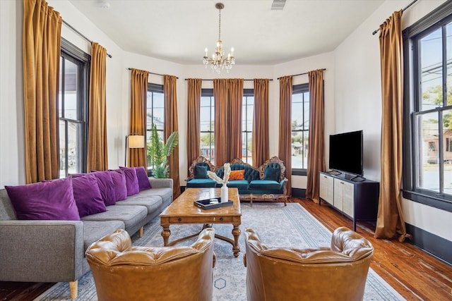 1920 Fulton St, Houston, TX 77009 - living room with a chandelier, wood finished floors, and baseboards