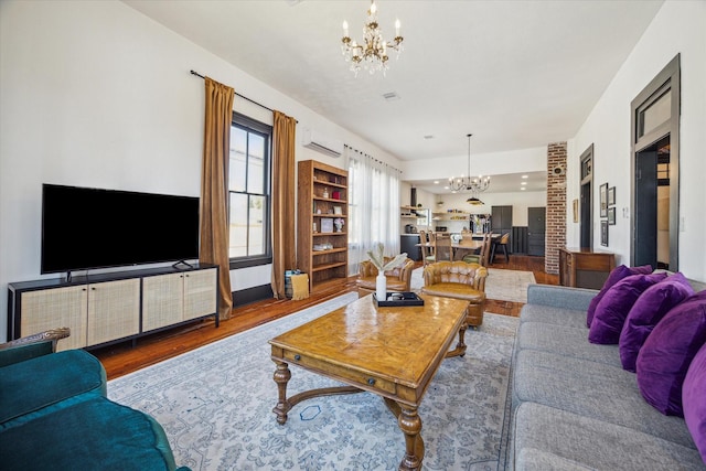 1920 Fulton St, Houston, TX 77009 - living area with a chandelier, wood finished floors, and a wall unit AC
