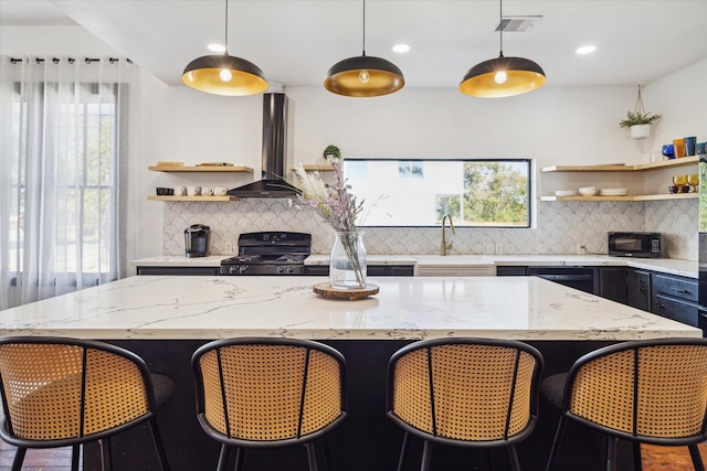 1920 Fulton St, Houston, TX 77009 - kitchen featuring open shelves, wall chimney range hood, black appliances, healthy amount of natural light, and recessed lighting