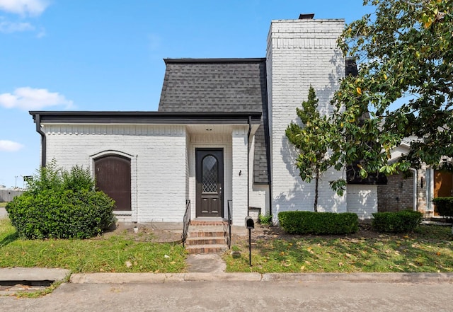 1903 Bittercreek Dr, Houston, TX 77042 - front facade with roof with shingles and brick siding