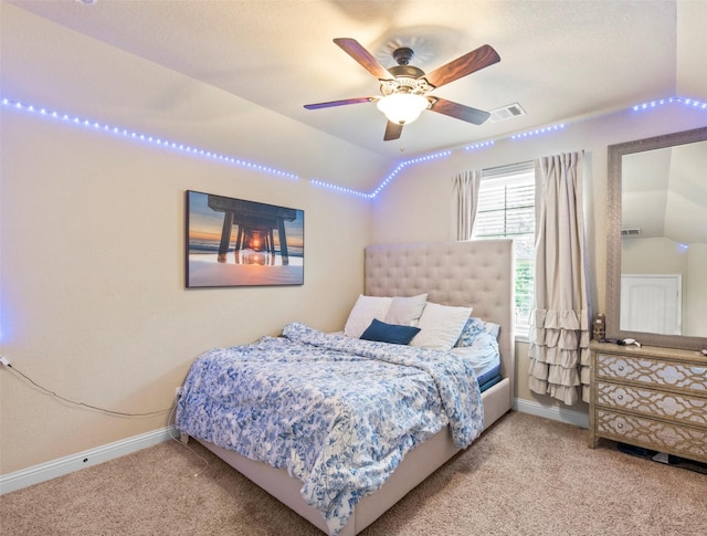 carpeted bedroom with baseboards, ceiling fan, lofted ceiling, and visible vents