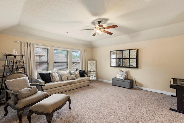carpeted living area featuring baseboards, a ceiling fan, lofted ceiling, and visible vents
