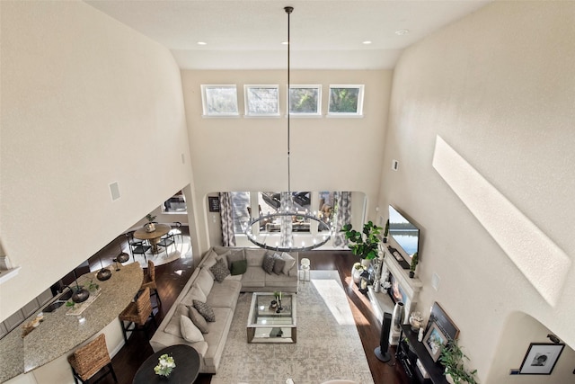 living room with wood finished floors, a high ceiling, and a wealth of natural light