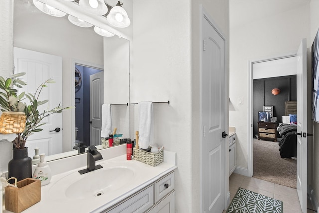 bathroom with vanity, ensuite bathroom, and tile patterned floors