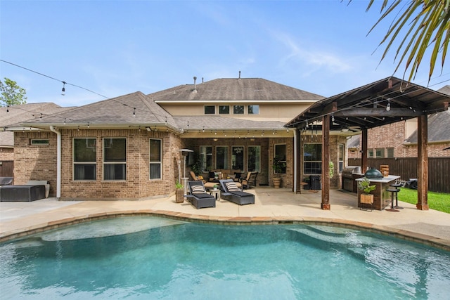 rear view of property with fence, area for grilling, an outdoor living space, a fenced in pool, and a patio area