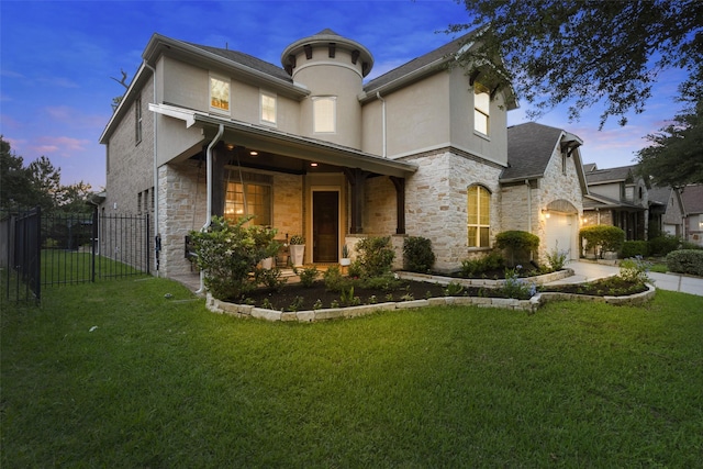 exterior space with a gate, fence, a yard, stone siding, and stucco siding