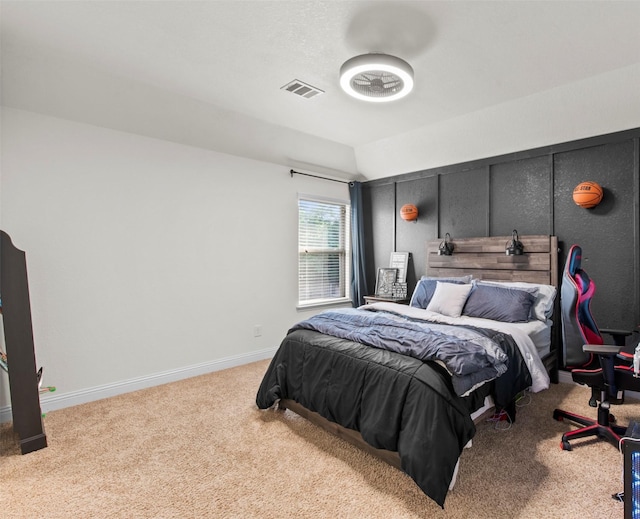 bedroom with visible vents, baseboards, lofted ceiling, and light carpet