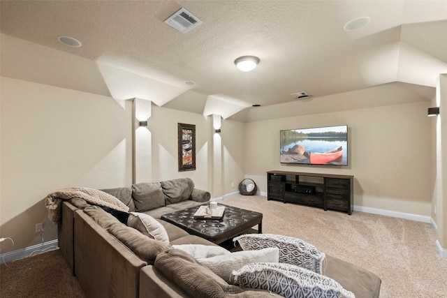 living area with baseboards, carpet, a textured ceiling, and visible vents