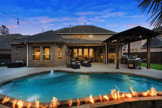 back of property at dusk with a fenced in pool, an outdoor living space with a fire pit, a gazebo, and fence