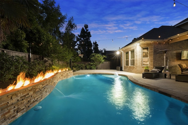 view of swimming pool featuring a fenced in pool, a fenced backyard, a patio area, and an outdoor fire pit