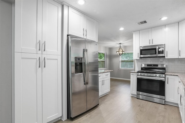 kitchen featuring stainless steel appliances, light wood-style flooring, backsplash, baseboards, and white cabinetry