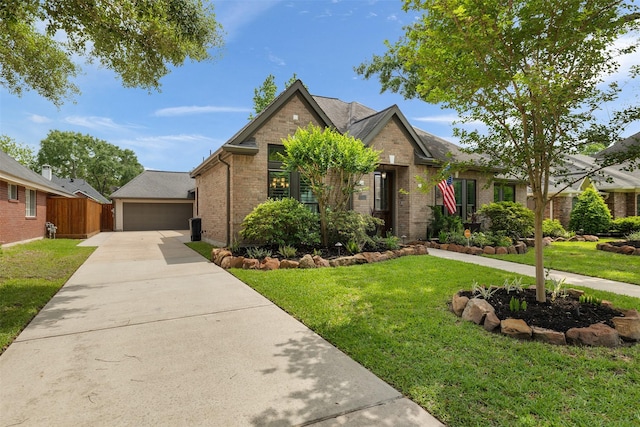 view of front of property featuring a front lawn, brick siding, and fence