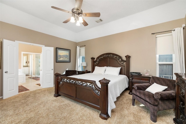 bedroom with ensuite bath, visible vents, carpet, and ceiling fan