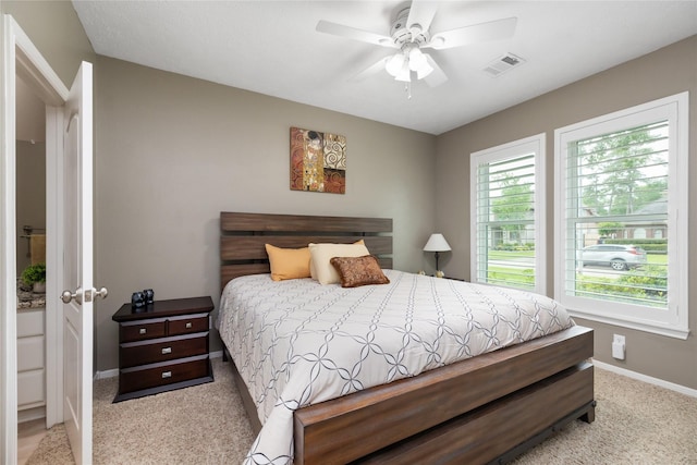 carpeted bedroom with visible vents, a ceiling fan, and baseboards