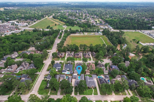 birds eye view of property with a view of trees and a residential view