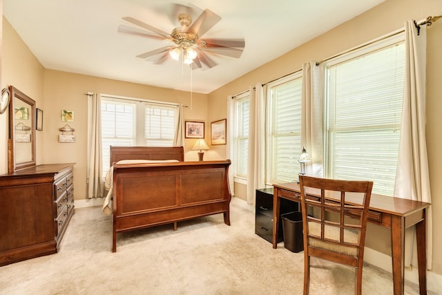 bedroom featuring light carpet and ceiling fan