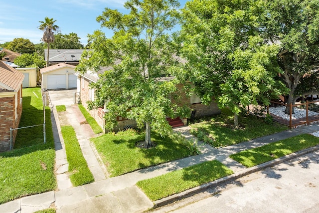 view of front of home featuring concrete driveway, a front lawn, brick siding, and a garage
