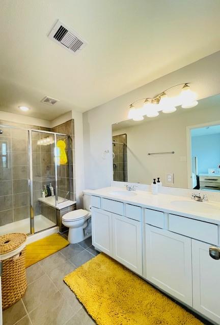 27915 Western Creek Ct, Katy, TX 77494 - bathroom featuring tile patterned floors, a sink, visible vents, and a stall shower