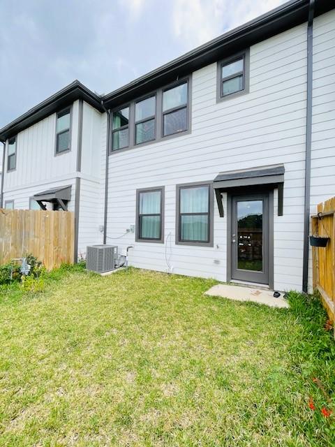 27915 Western Creek Ct, Katy, TX 77494 - rear view of property with a lawn, central AC, and fence
