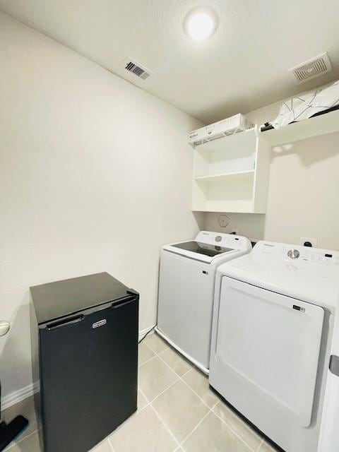 27915 Western Creek Ct, Katy, TX 77494 - laundry area with visible vents, washer and clothes dryer, light tile patterned floors, and laundry area