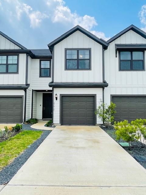 27915 Western Creek Ct, Katy, TX 77494 - view of property with board and batten siding, concrete driveway, and a garage