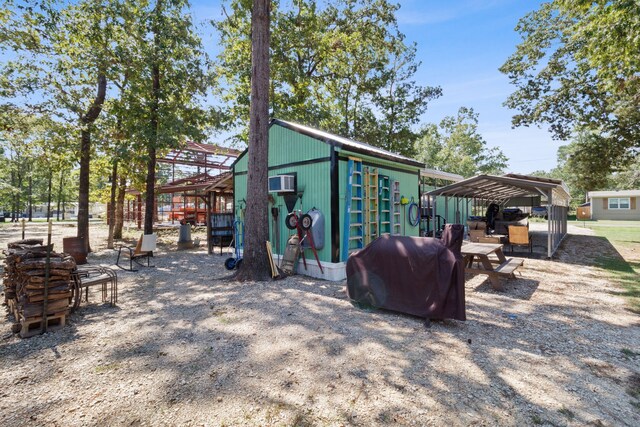 191 Trinidad Ln, Point Blank, TX 77364 - exterior space with an outbuilding and a wall mounted AC