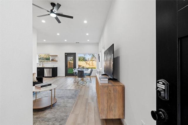 living area featuring recessed lighting, a ceiling fan, and light wood-type flooring