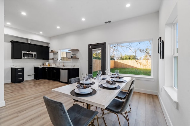 dining area with a healthy amount of sunlight, light wood-style flooring, visible vents, and recessed lighting