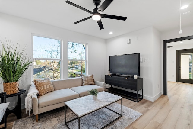 living room with light wood-style flooring, a wealth of natural light, recessed lighting, and a ceiling fan