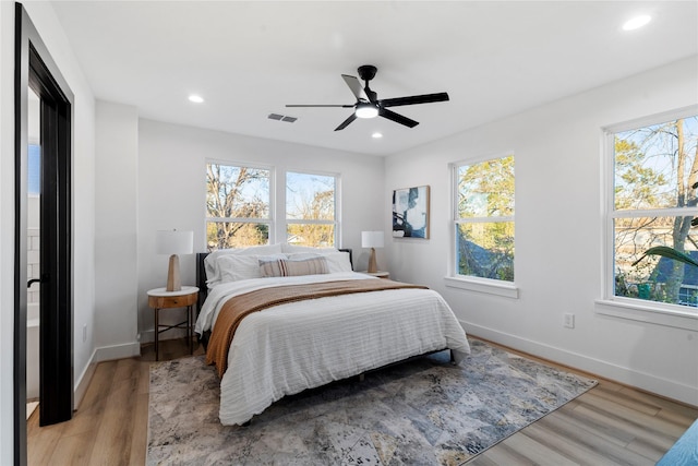 bedroom with baseboards, visible vents, recessed lighting, light wood-style floors, and ceiling fan