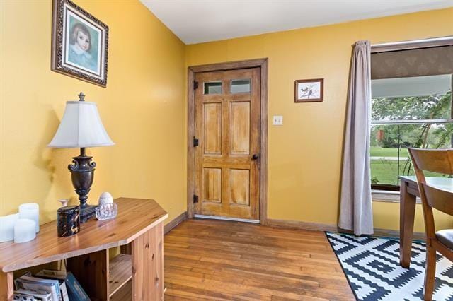 entryway with wood finished floors and baseboards